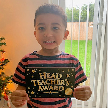 A child receiving his Headteacher's Award